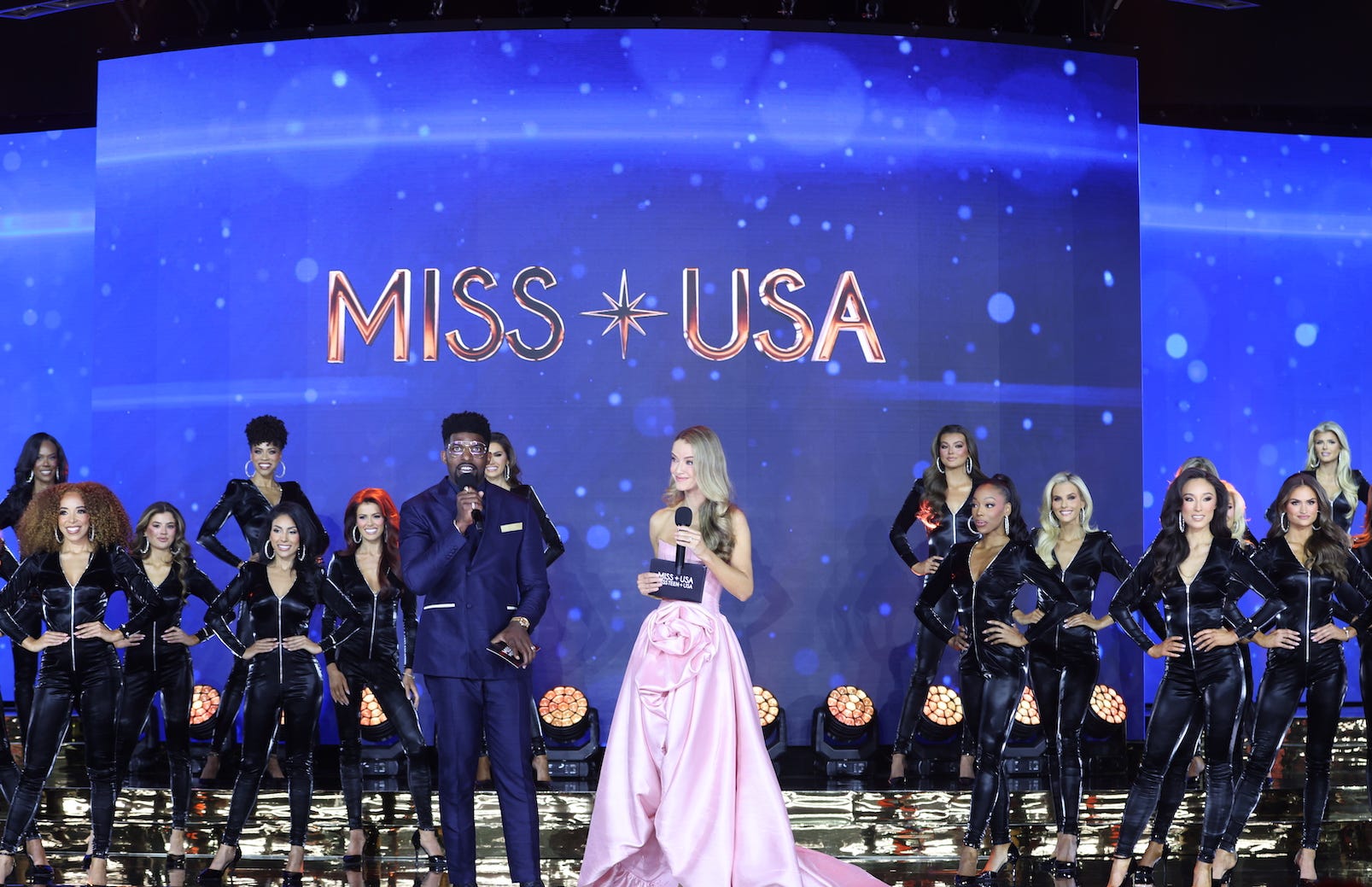 Hosts Emmanuel Acho and Olivia Jordan with the 2025 Miss USA contestants.