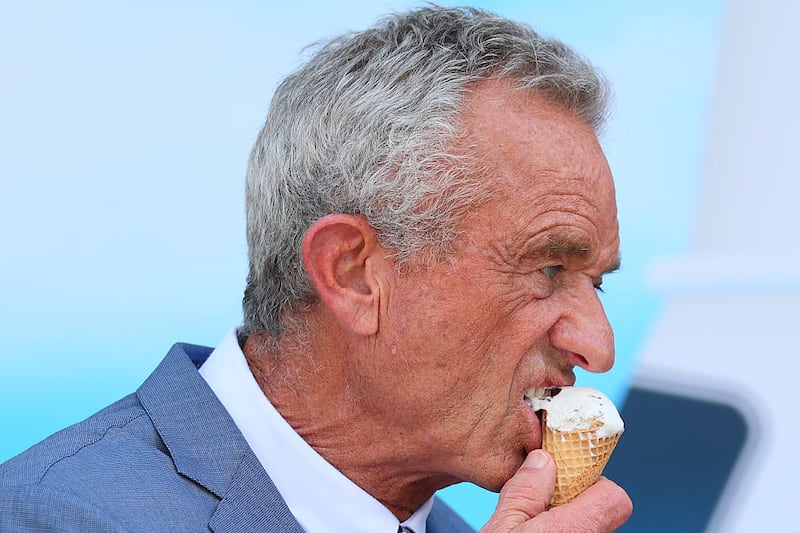 Health and Human Services (HHS) Secretary Robert F. Kennedy Jr. eats a mint chocolate chip ice cream cone during a press conference on the steps of the United States Department of Agriculture  on July 14, 2025 in Washington, DC.