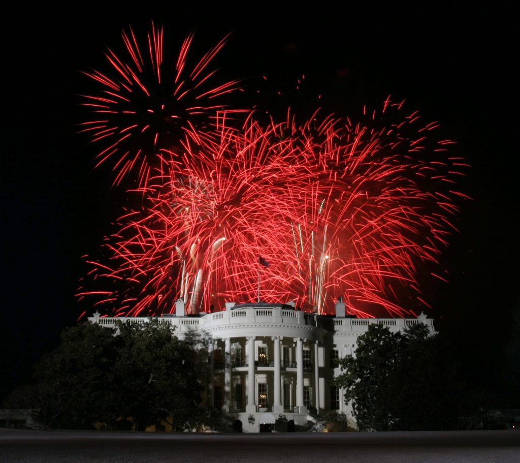 Red fireworks exploding over the White House.