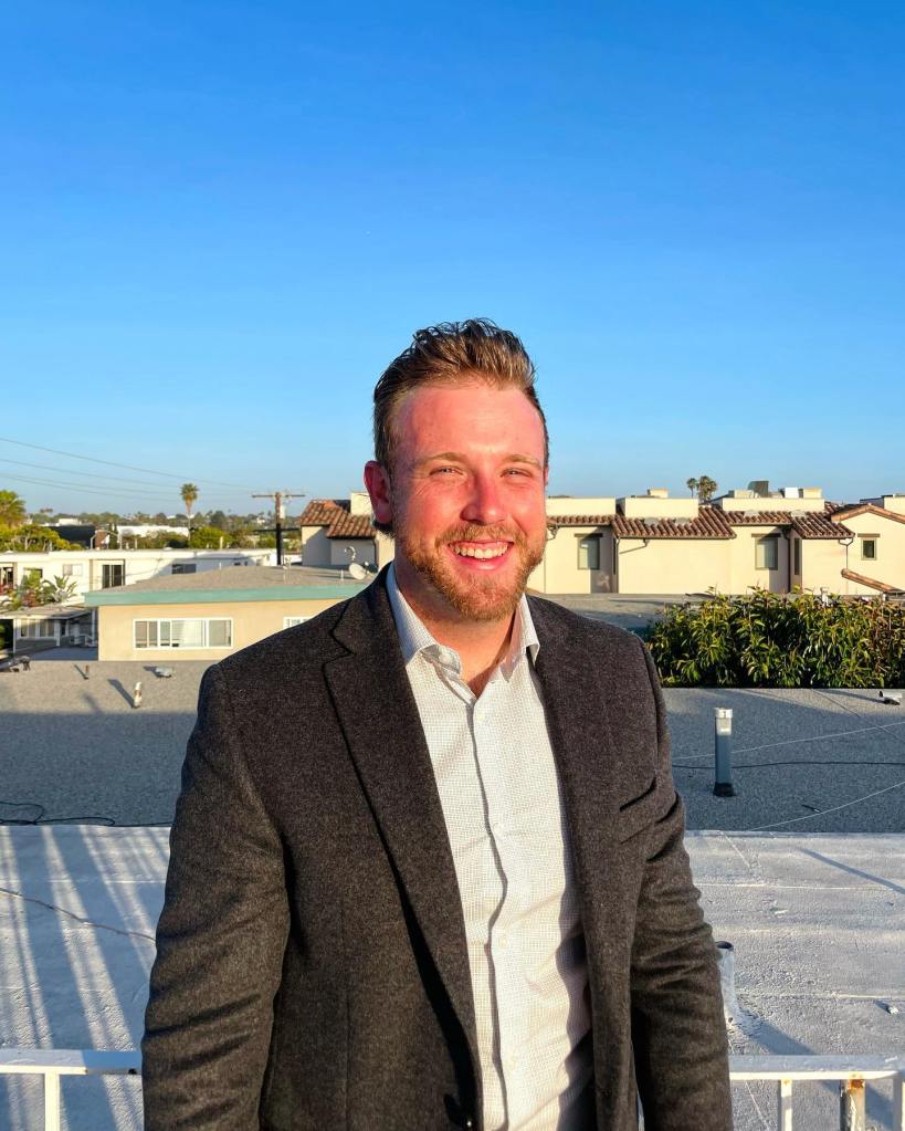Matthew Cohn, a man with a beard, smiling.