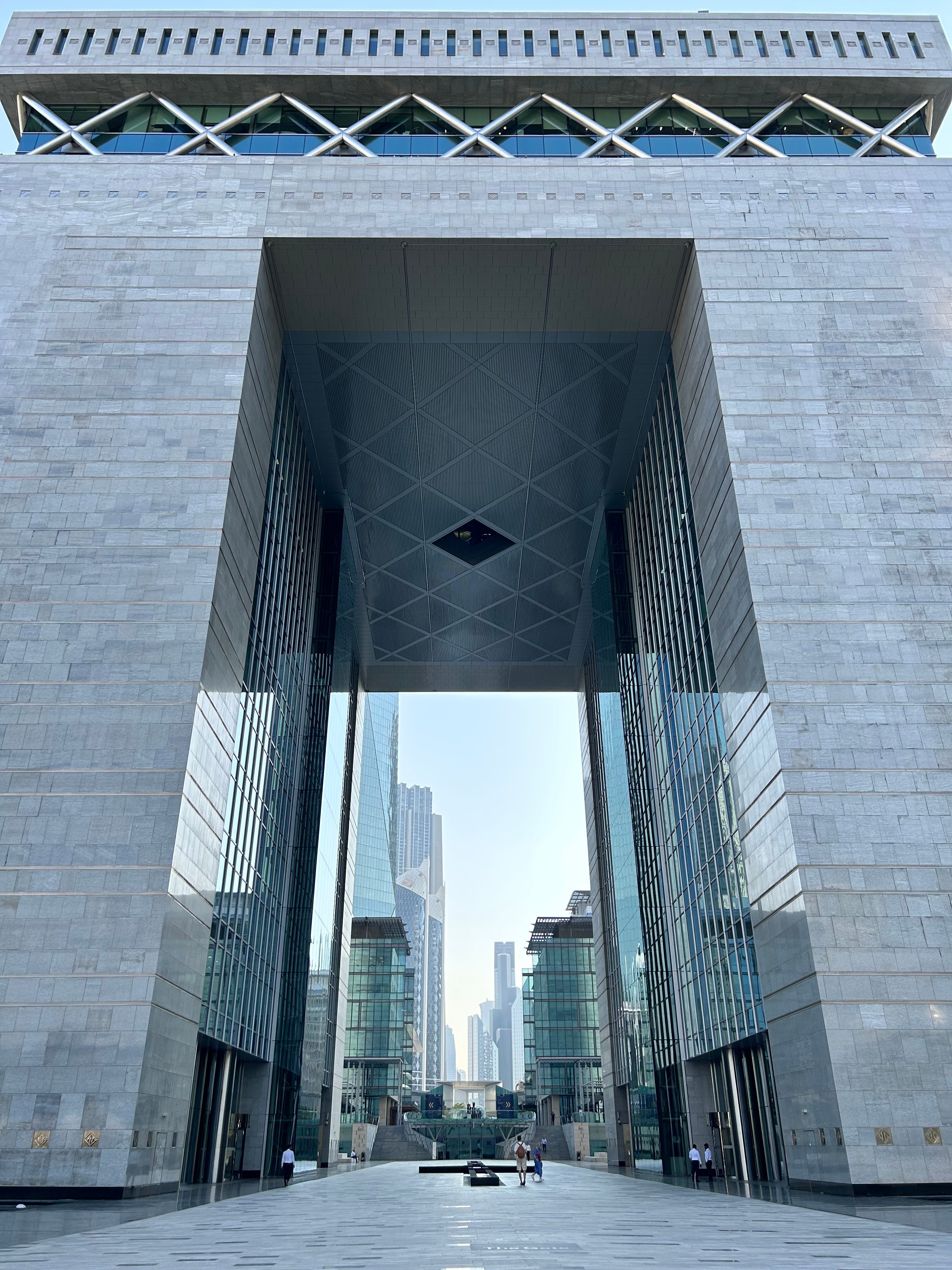 Looking up a large arched building in Dubai's DIFC region