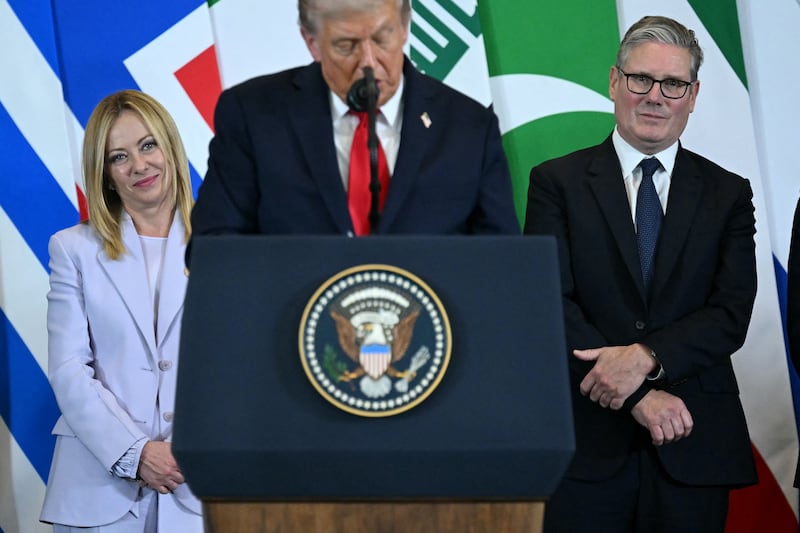 US President Donald Trump (C) speaks as Italian Prime Minister Giorgia Meloni (L) and Britain's Prime Minister Keir Starmer watch during the Sharm El-Sheikh Peace Summit in the Egyptian Red Sea resort town of Sharm el-Sheikh on October 13, 2025. Trump on October 13 hailed a Gaza summit in Egypt as a