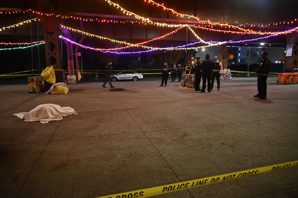 Crime scene at East 124 Street and Park Avenue with a covered body.