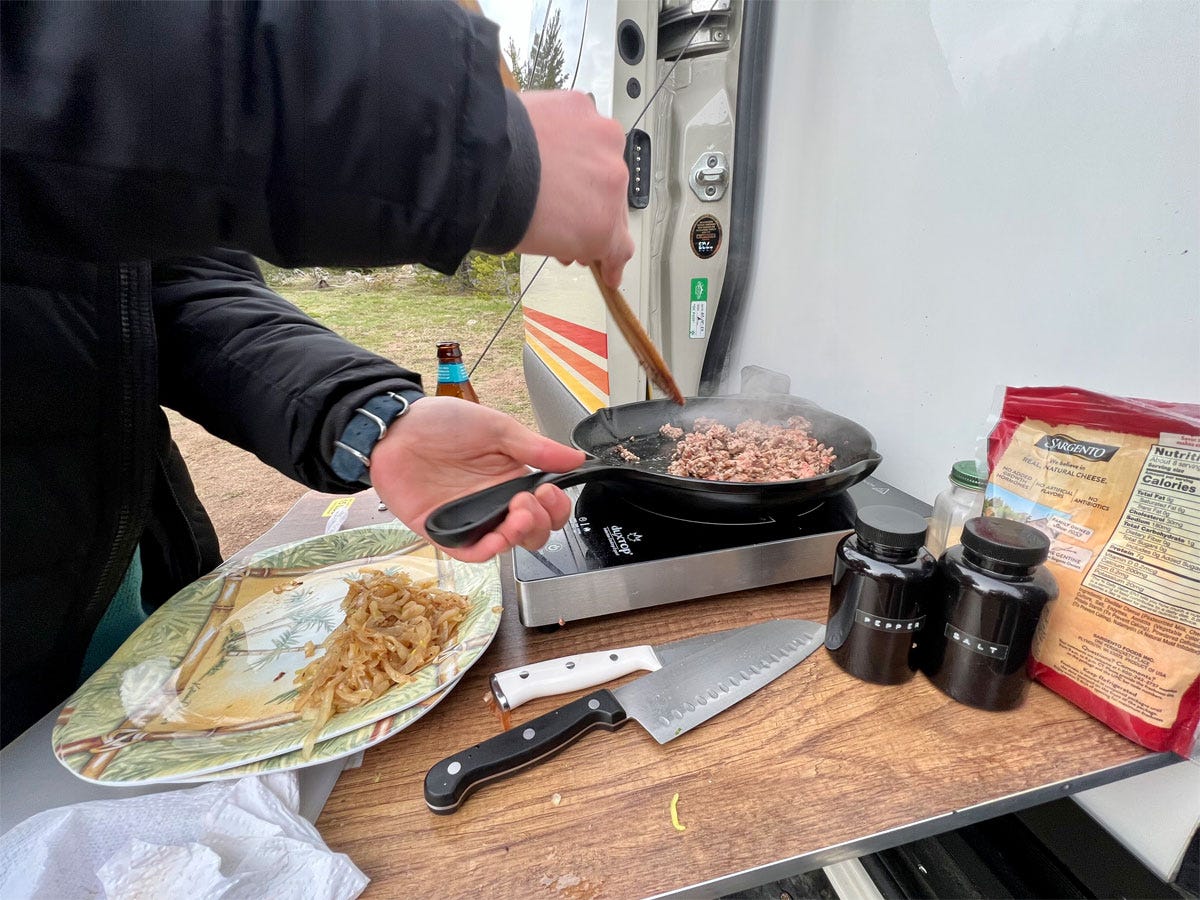 pan cooking meet outside of van