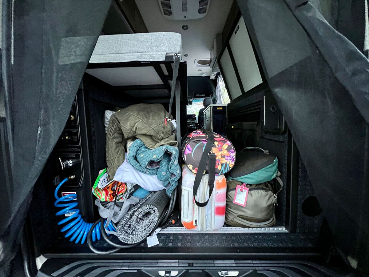 back of camper van with belongings in trunk