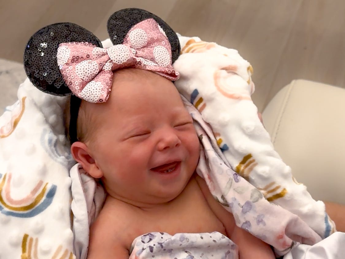 A newborn wearing Minnie Mouse ears