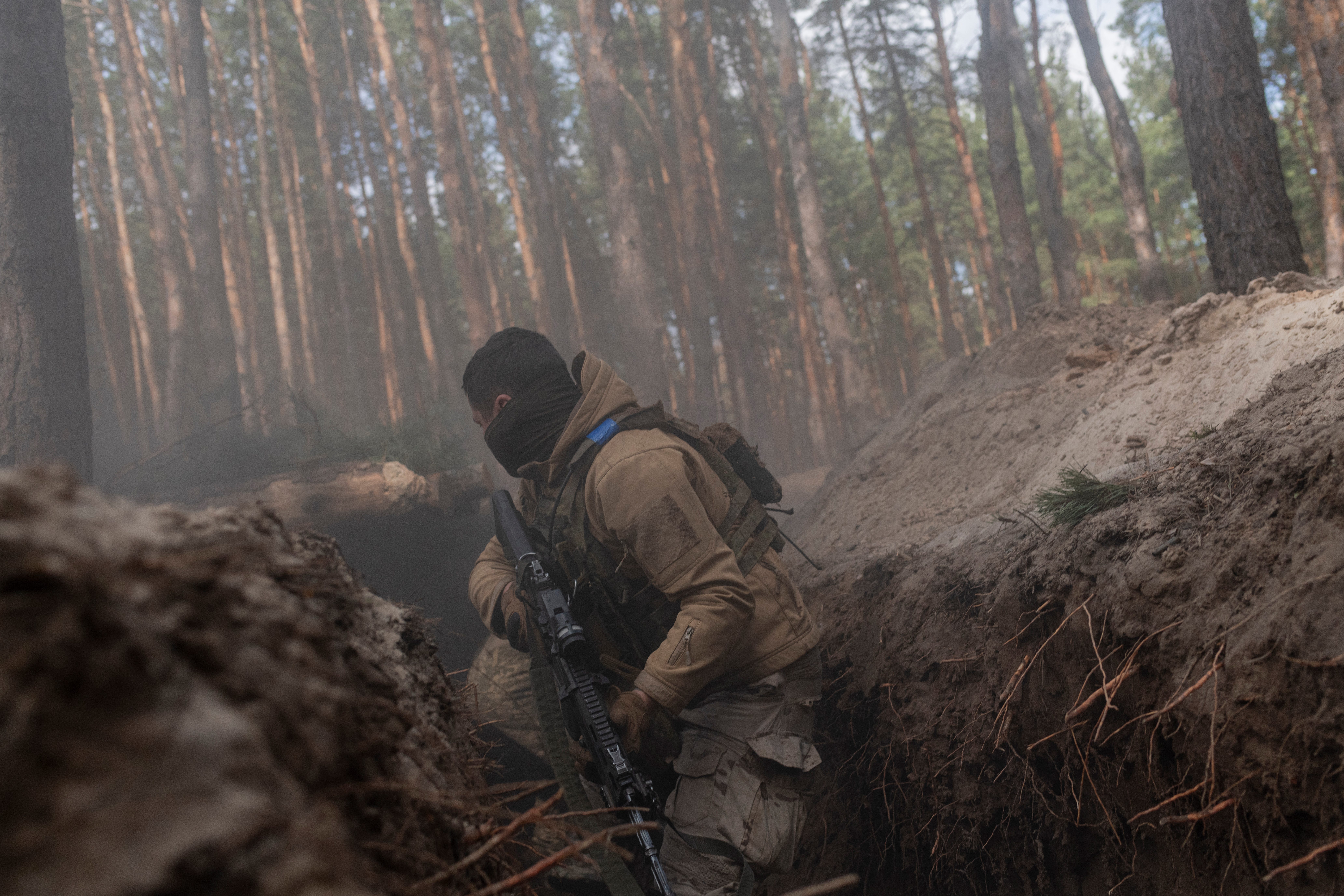 Recruits of 72nd Mechanized Brigade conduct assault training in a trench during basic training on March 28, 2025 in Donetsk Oblast, Ukraine.