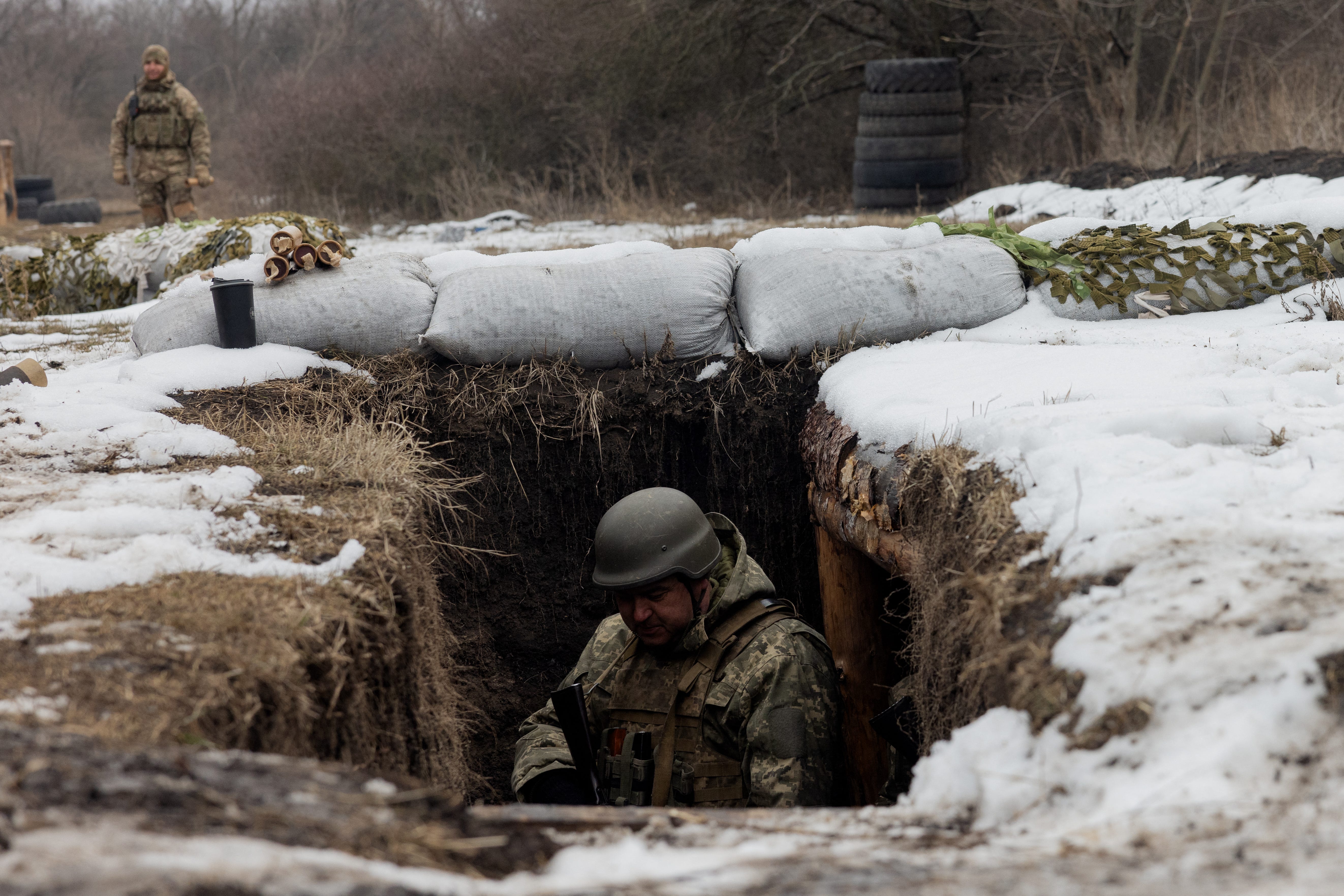 A Ukrainian serviceman of the 24th Mechanized Brigade mans a position in a trench, as he takes part in a training drill at an undisclosed location in the eastern region of Ukraine on March 4, 2025, amid the Russian invasion of Ukraine.