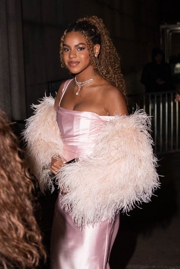 Blue Ivy Carter in a pink satin dress with a fluffy pink boa at the 27th Annual Angel Ball.