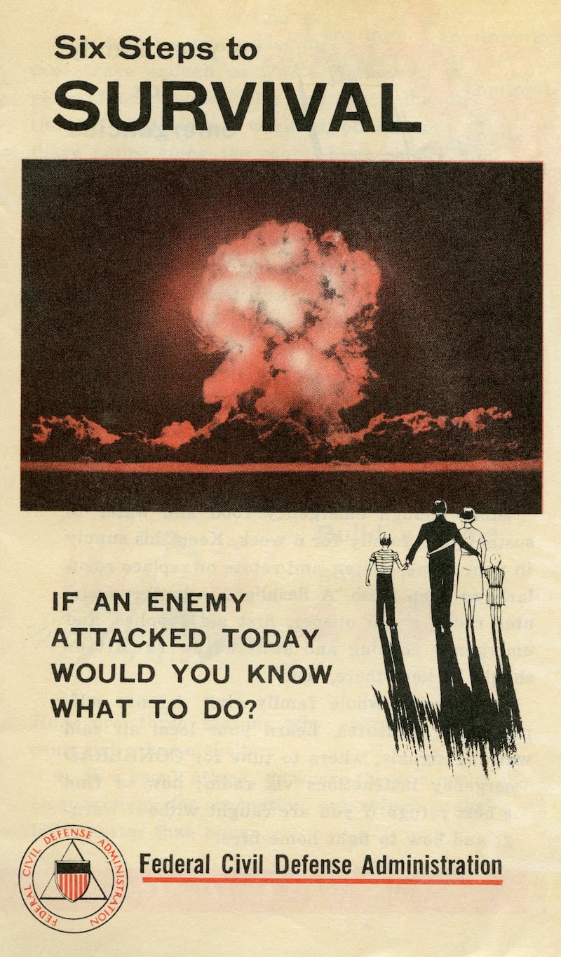 An informational pamphlet shows a photograph of a mushroom cloud explosion, circa 1957.