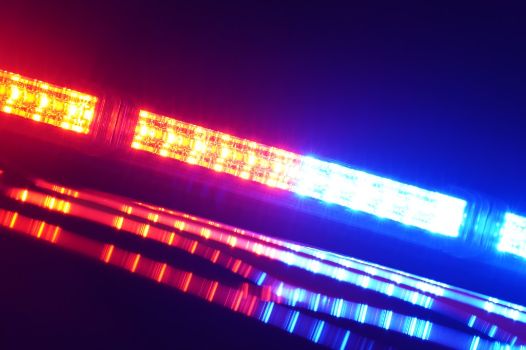 Police car emergency lights flashing red and blue.