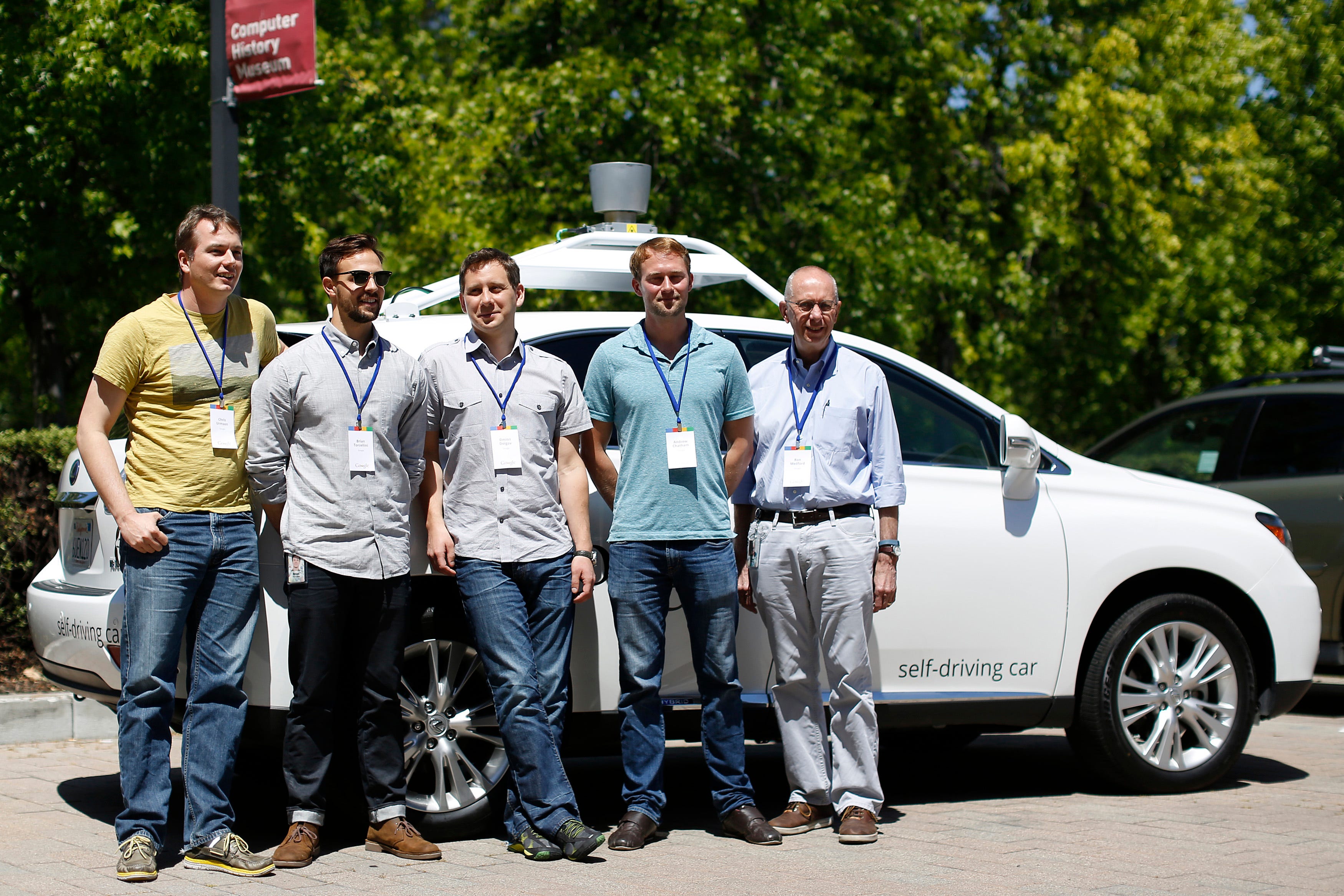 Chris Urmson, (L) director of Google's Self-Driving Car Project, and team members Brian Torcellini, Dmitri Dolgov, Andrew Chatham, and Ron Medford (R), who is director of safety for the project, pose for a photograph in front of a self-driving car at the Computer History Museum after a presentation in Mountain View, California May 13, 2014.
