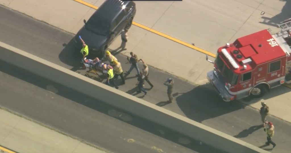 Saldivar being carried off the freeway after allegedly killing Nunez.
