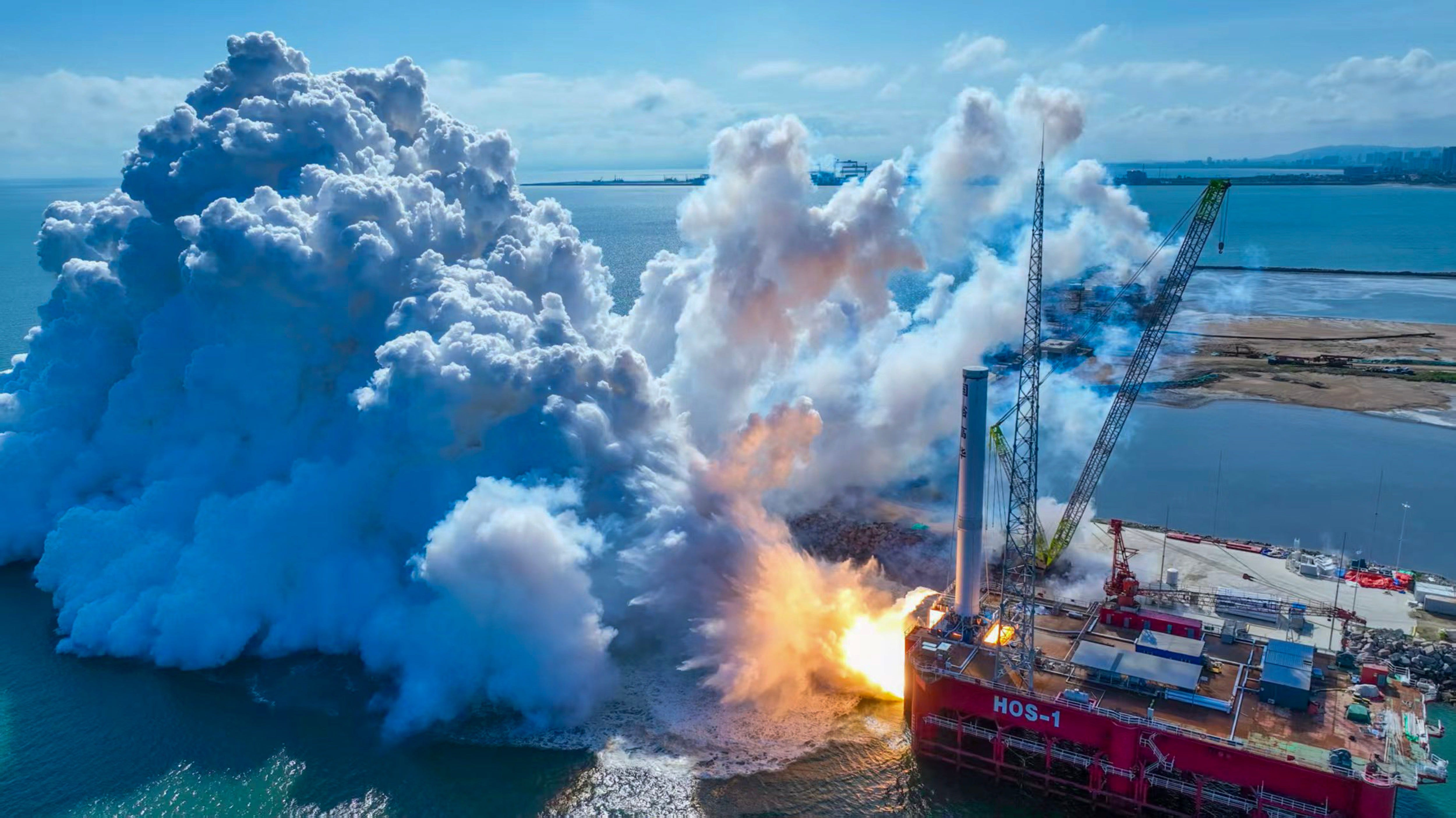 A propulsion system test is conducted near a platform in the ocean with a large plume of smoke.