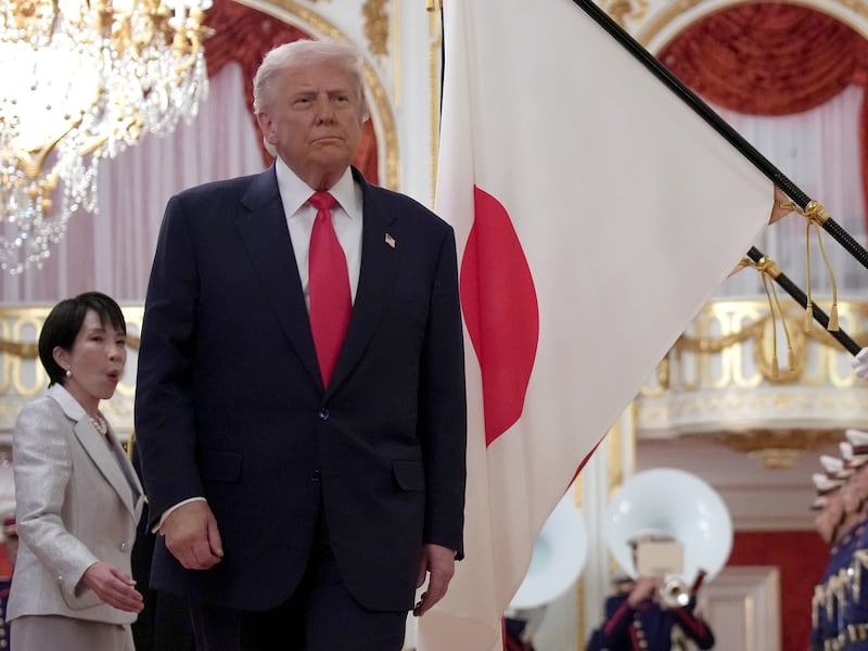 President Donald Trump views an honor guard with Japanese Prime Minister Sanae Takaichi at Akasaka Palace