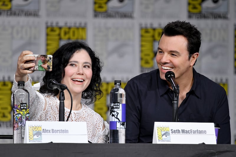 SAN DIEGO, CA - JULY 21:  Alex Borstein (L) and Seth MacFarlane take a selfie onstage at the "American Dad" and "Family Guy"  Panel during Comic-Con International 2018 at San Diego Convention Center on July 21, 2018 in San Diego, California.  (Photo by Mike Coppola/Getty Images)