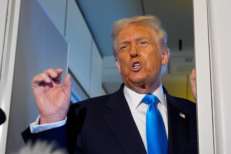 President Donald Trump speaks to journalists aboard Air Force One en route to South Korea on October 29, 2025 in Japan.