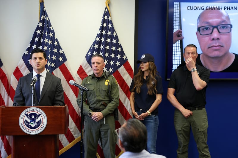 US Attorney for the Central District of California Bilal Essayli (L) speaks during a news conference alongside (L/R) Gregory Bovino, Chief Patrol Agent at the El Centro Sector of US Customs and Border Patrol,  Department of Homeland Security Secretary Kristi Noem and Acting ICE Director Todd Lyons,