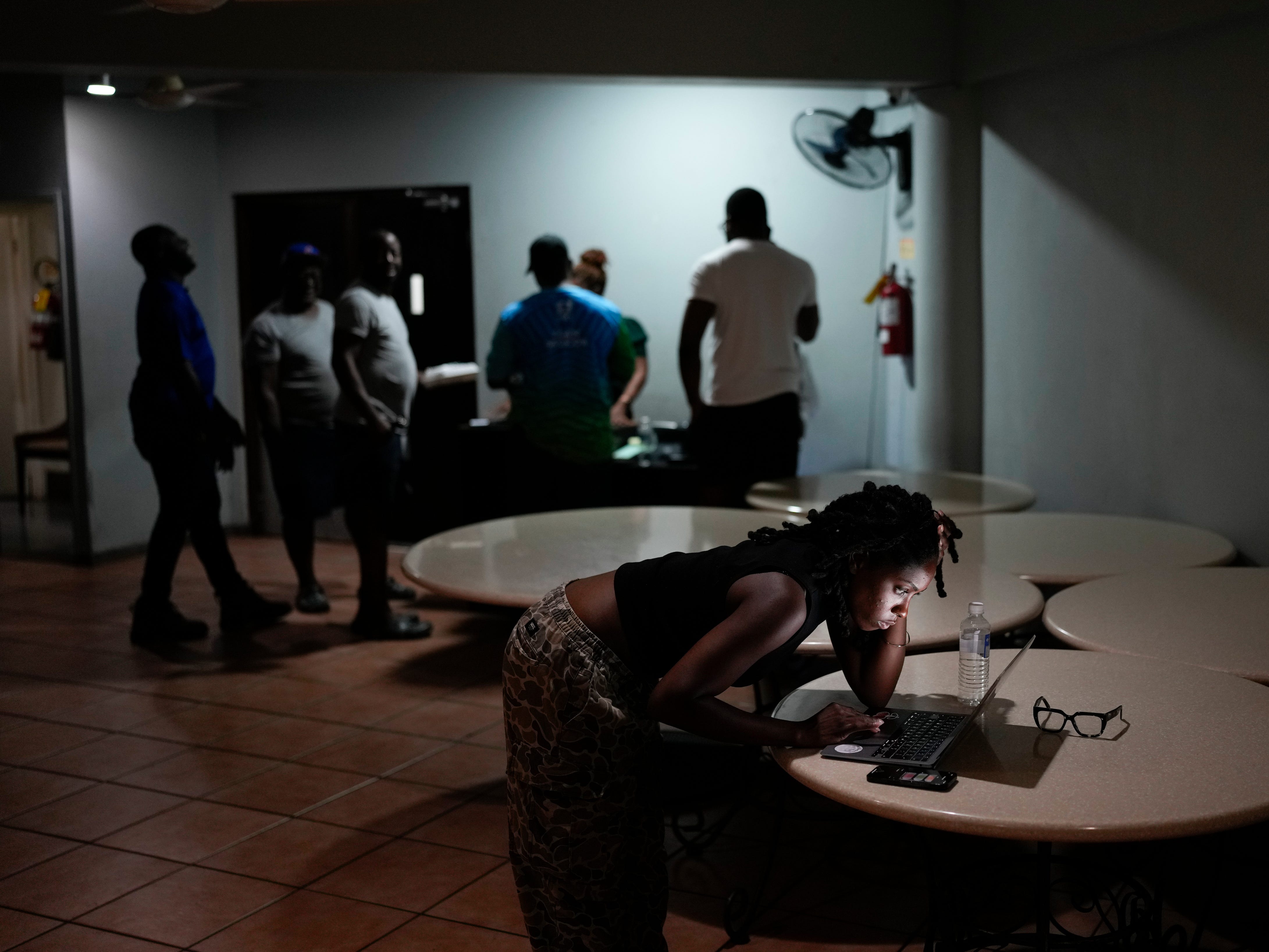 A woman video chats with a friend ahead of Hurricane Melissa's forecast arrival in Kingston, Jamaica.