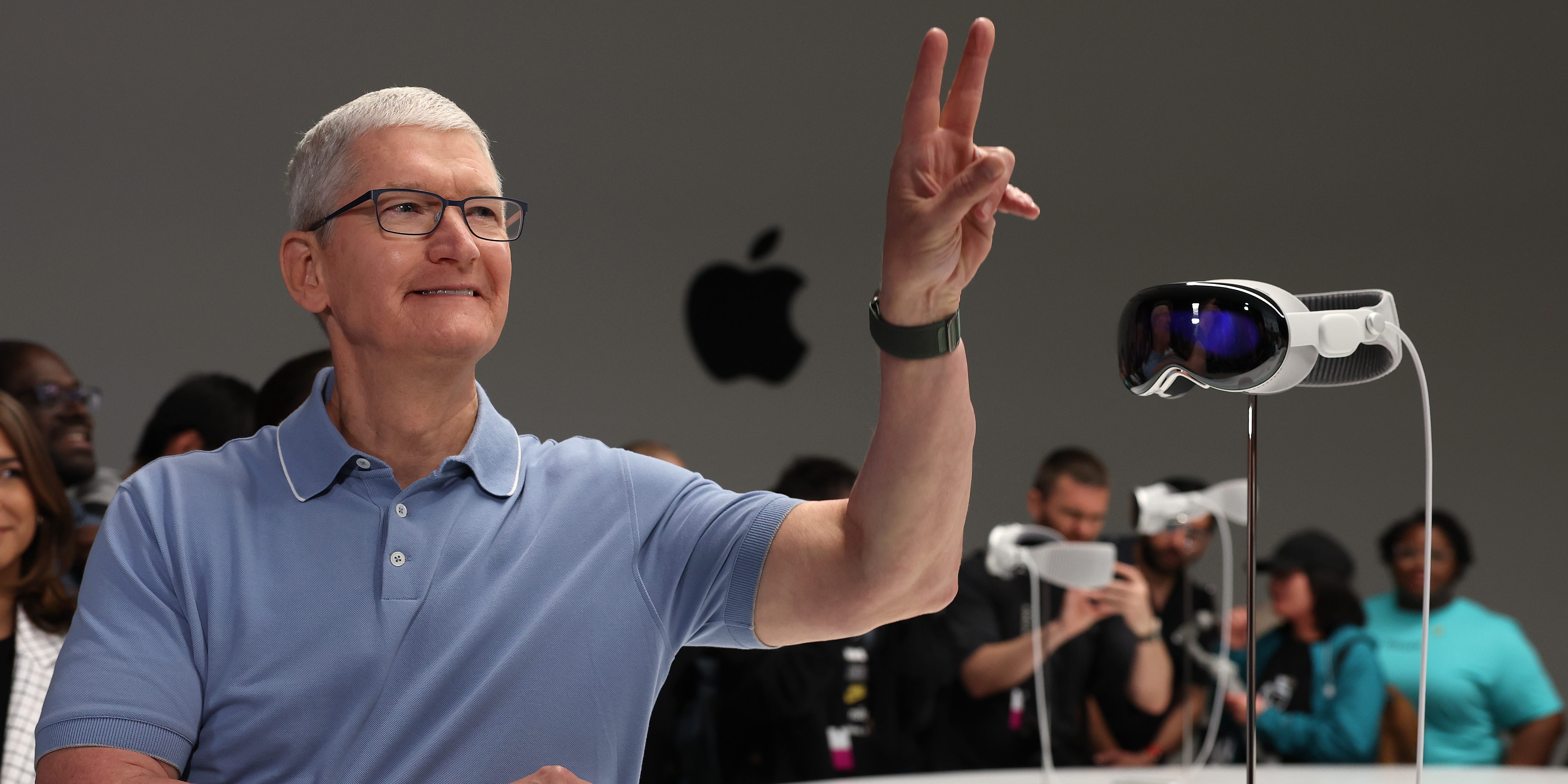 Apple CEO Tim Cook stands next to an Apple Vision Pro headset, June 2023
