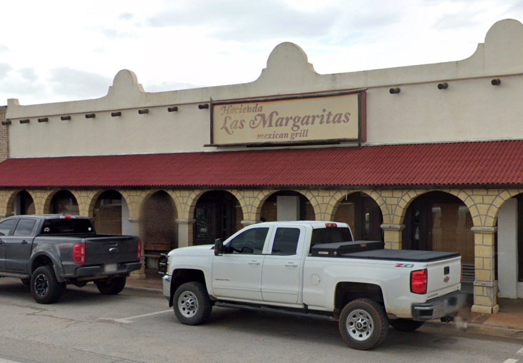 Hacienda Las Margaritas Bar & Grill with two pickup trucks parked in front.