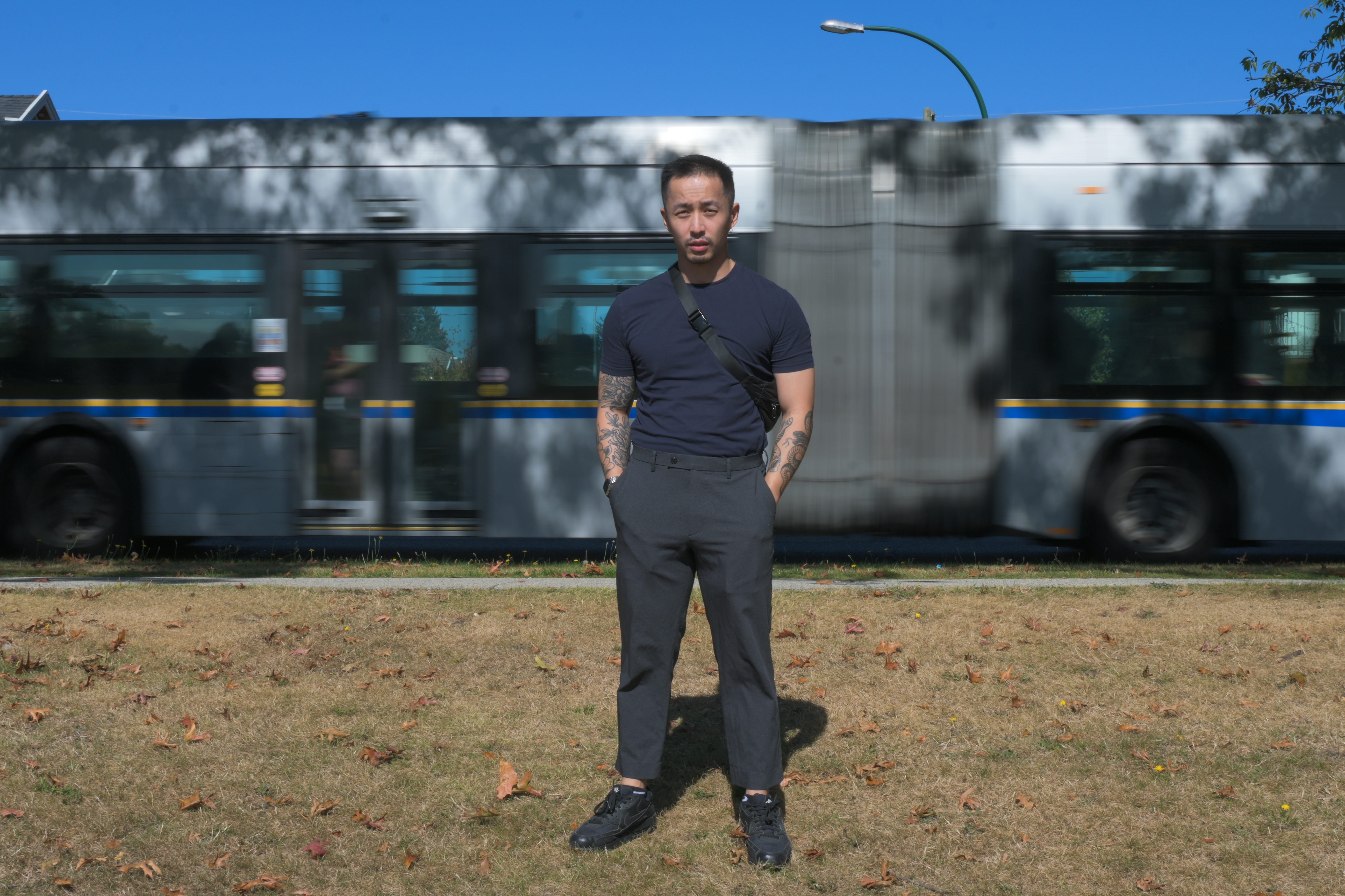 A man standing in front of a train.