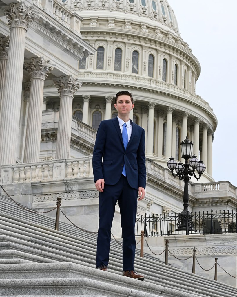 Eric Tarpinian-Jachym poses for a photo outside the US Capitol.