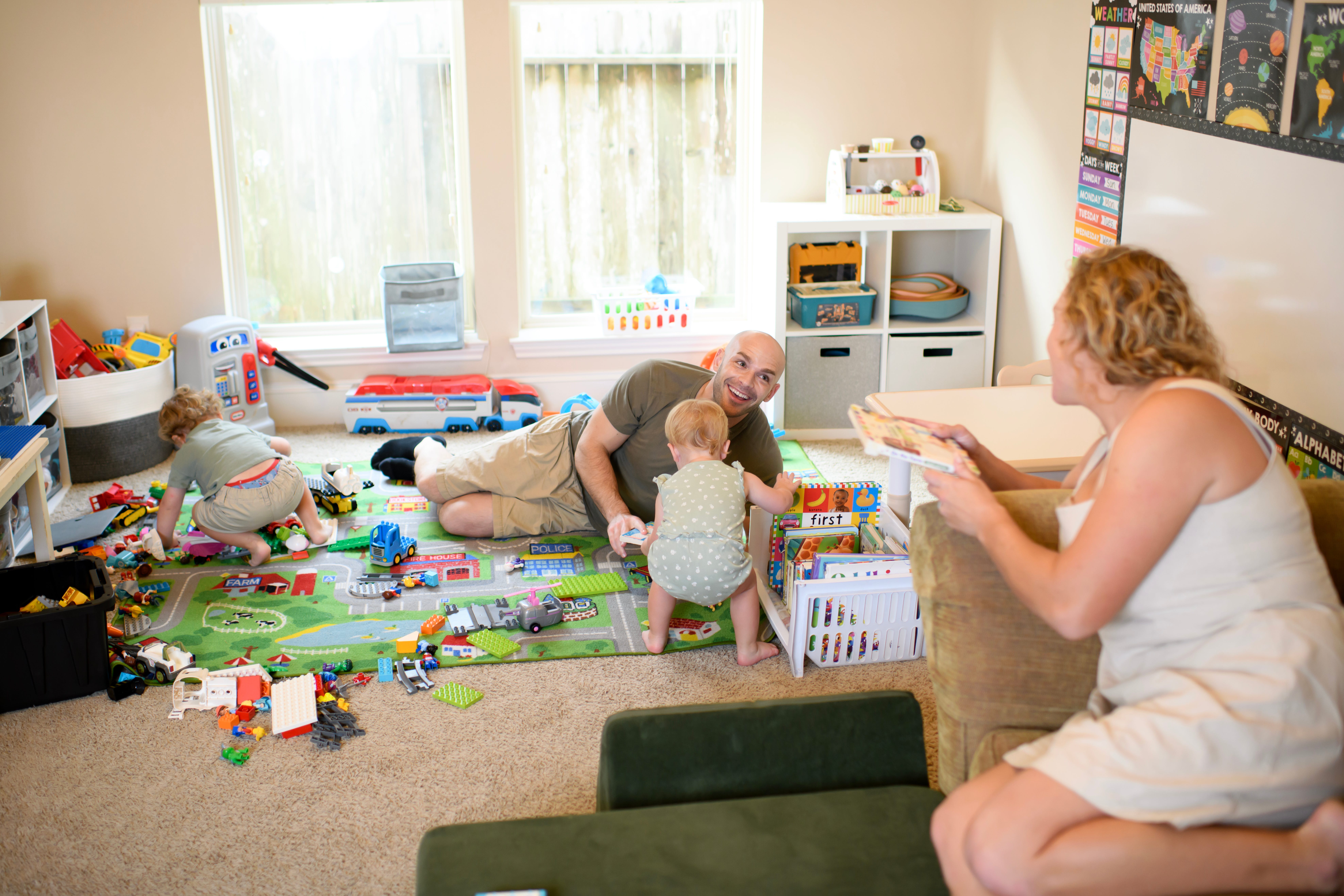 Erin Rost and her husband playing with their kids.