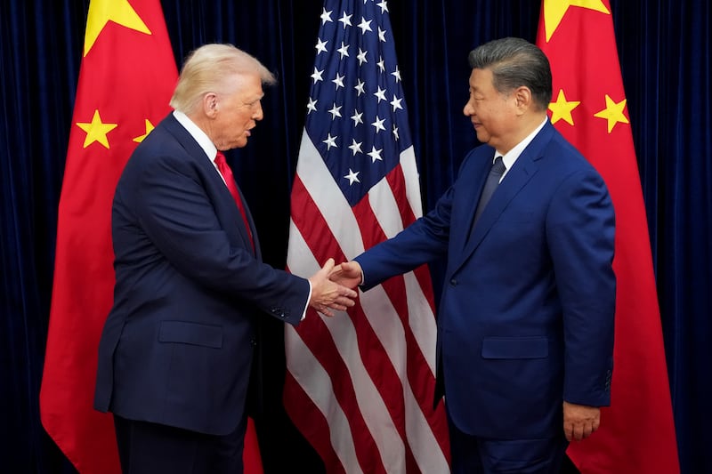 U.S. President Donald Trump greets Chinese President Xi Jinping ahead of a bilateral meeting at Gimhae Air Base on October 30, 2025 in Busan, South Korea. Trump is meeting Xi for the first time since taking office for his second term, following months of growing tension between both countries. (Photo by Andrew Harnik/Getty Images)