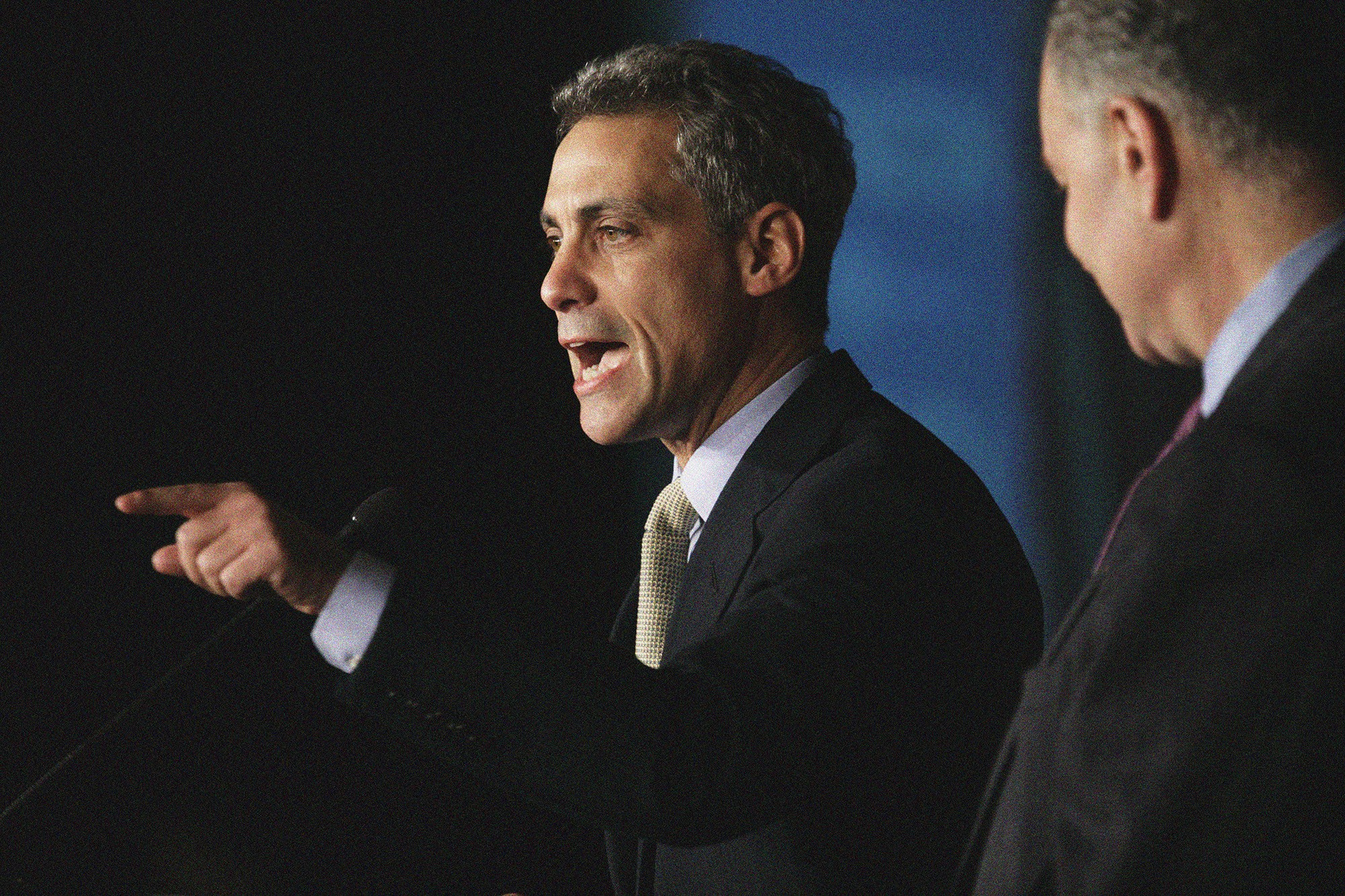 Rahm Emanuel speaking at a podium pointing his finger.