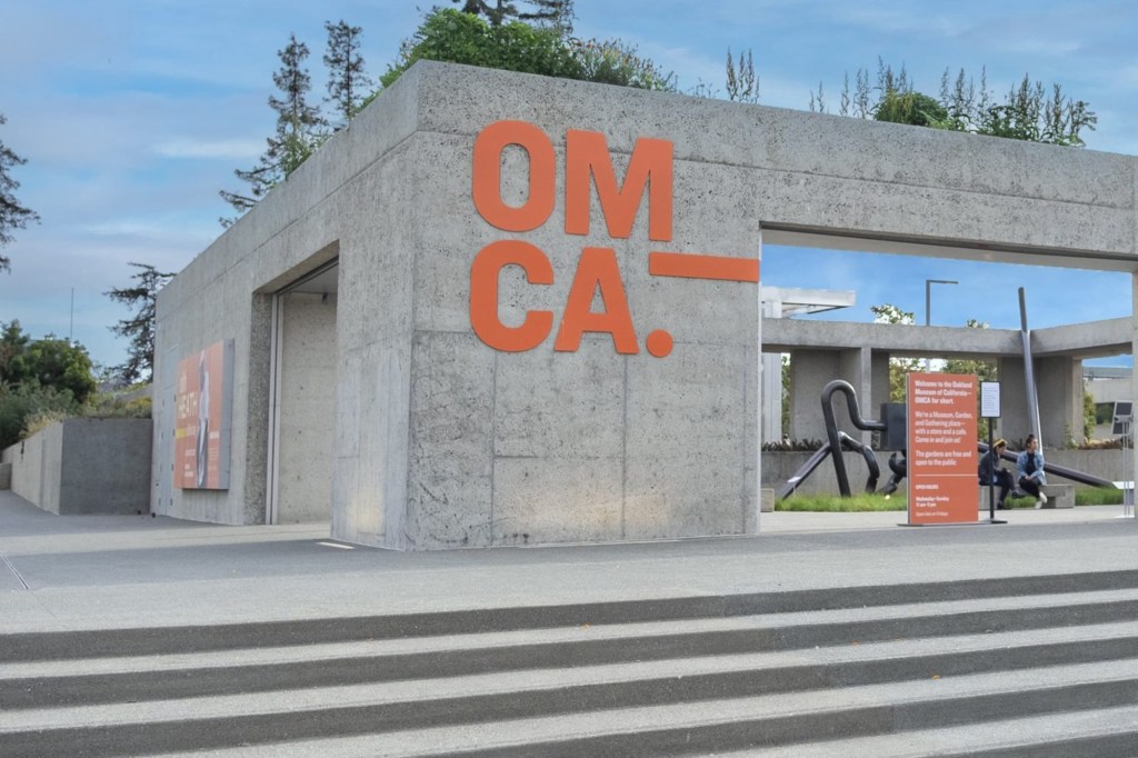 Oakland Museum of California (OMCA) exterior with its large orange logo.