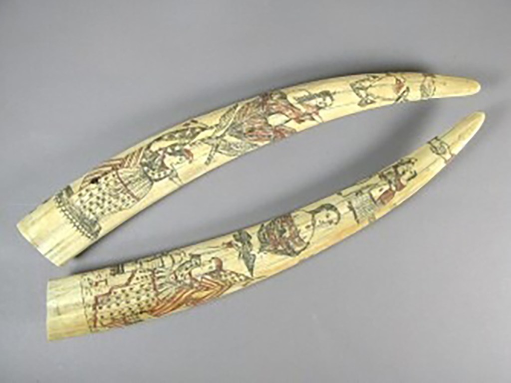 Two carved and painted tusks.