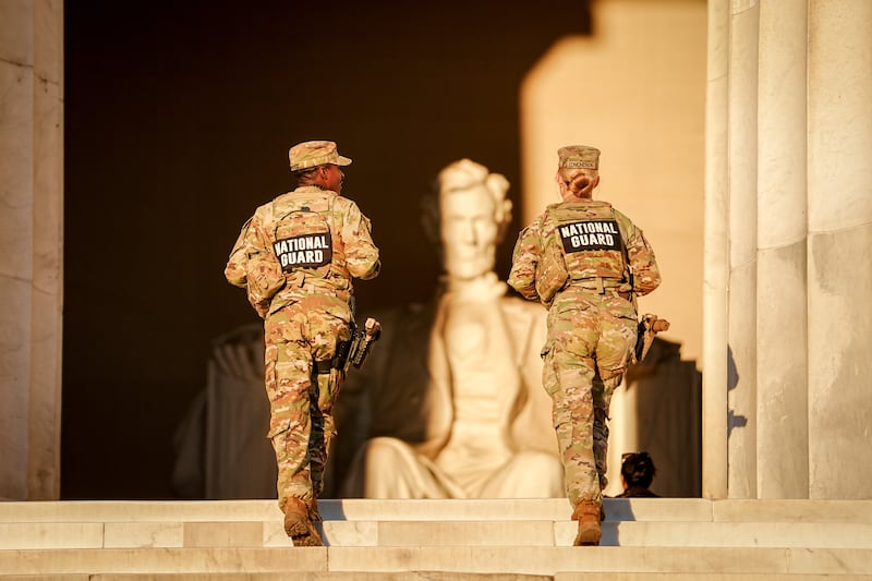 US National Guard soldiers walk up the steps to the Lincoln Memorial