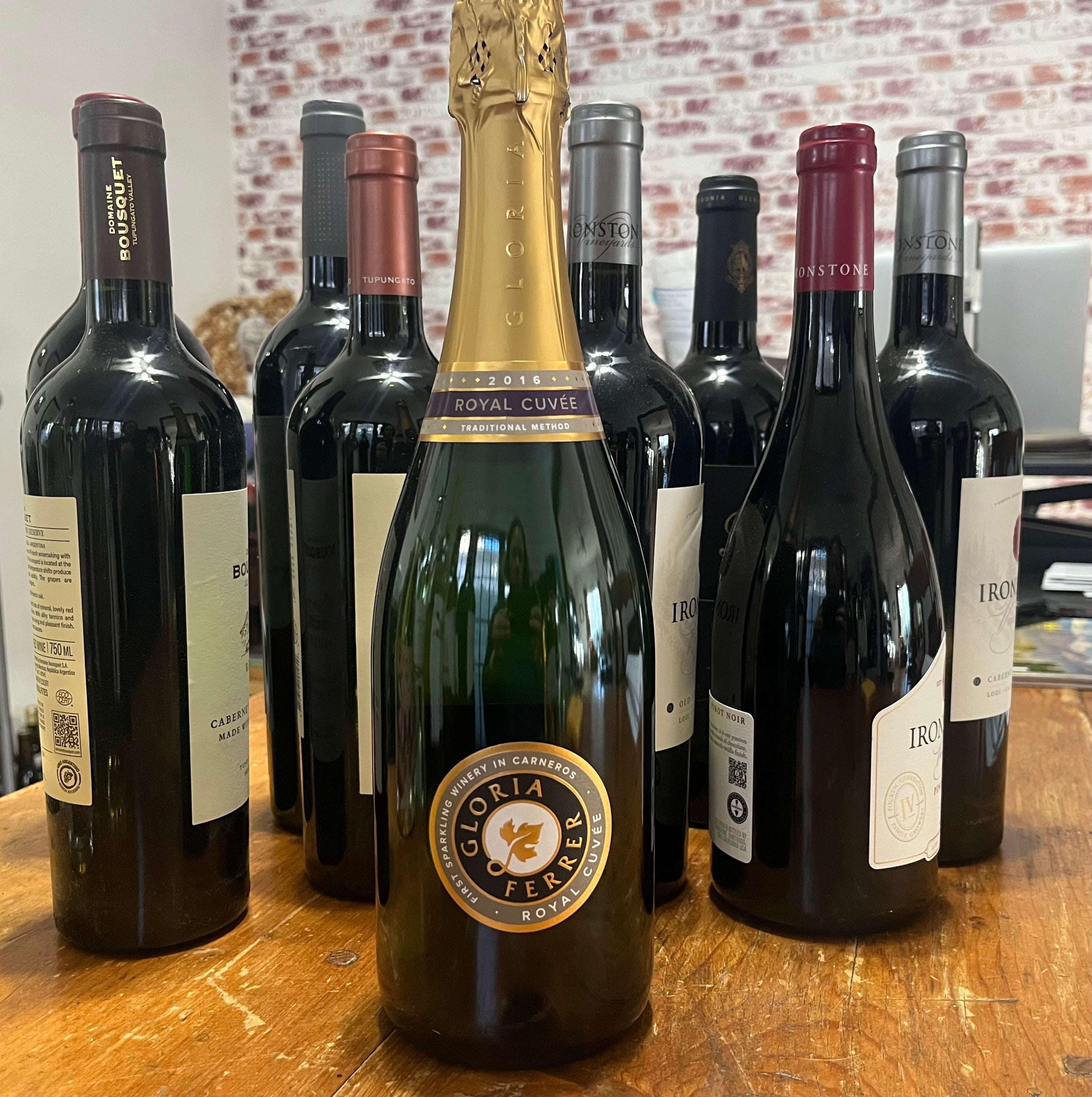 bottle of bubbly wine in front of other wine bottles