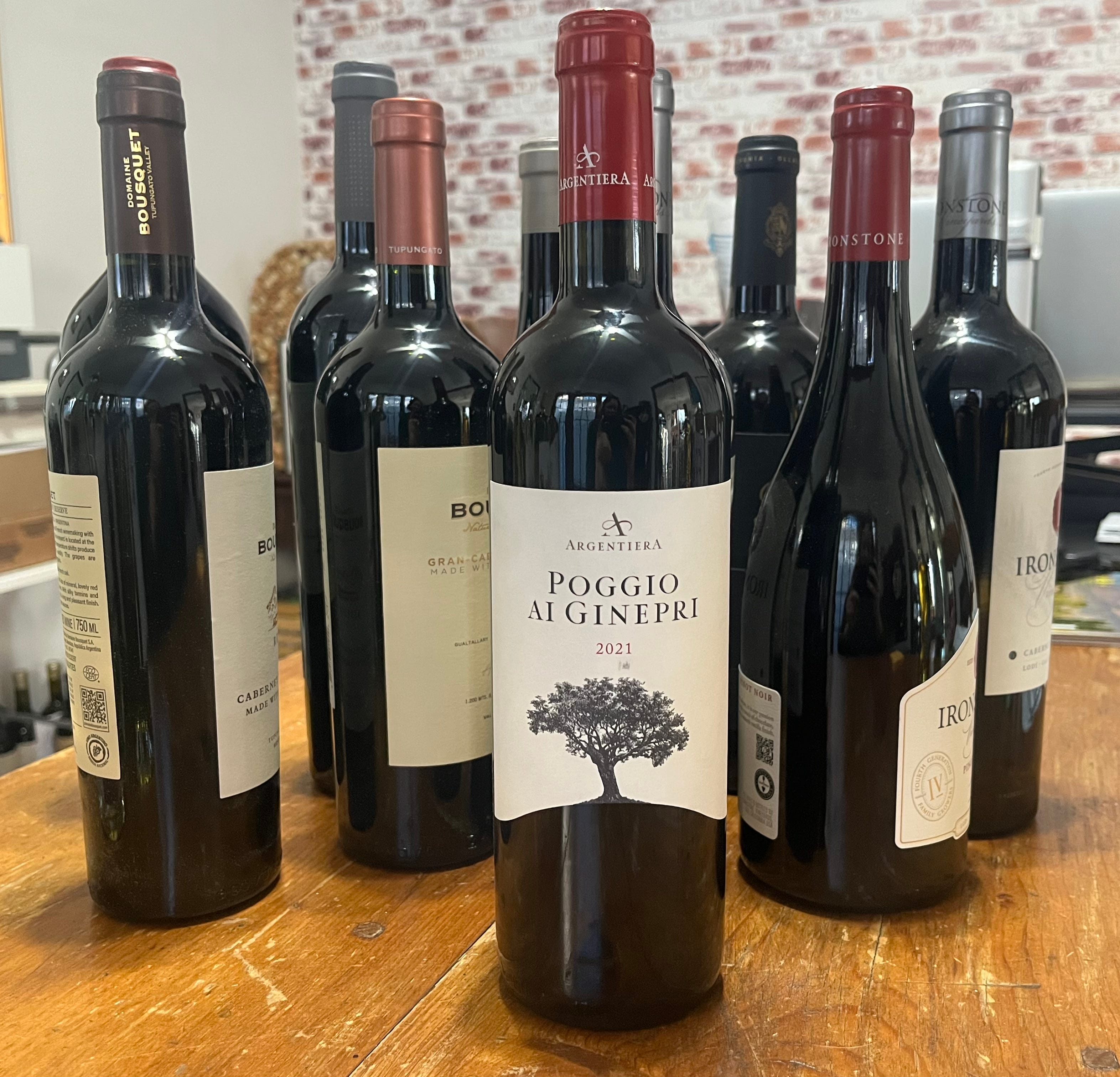 bottle of italian red wine in front of other bottles of wine