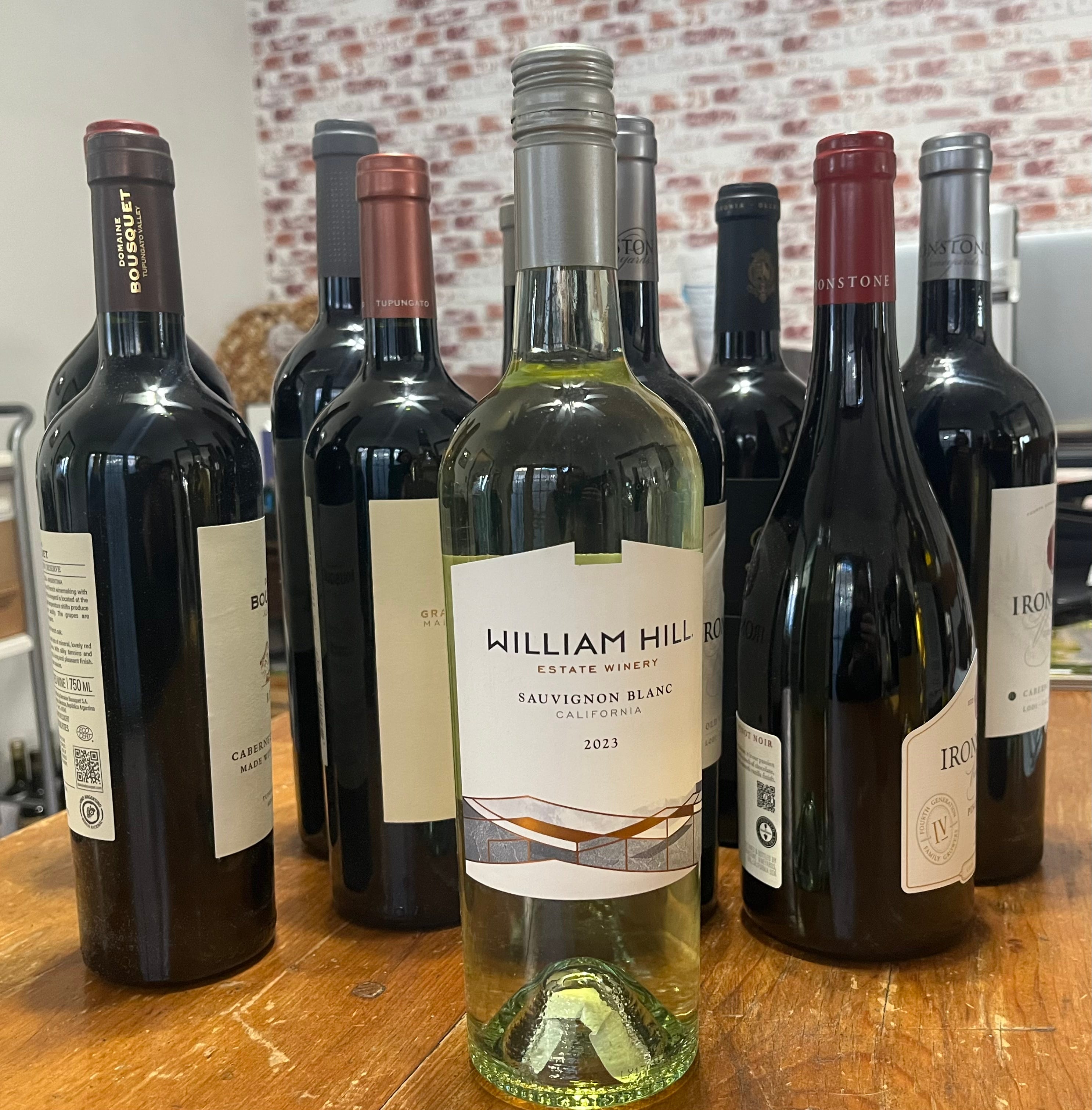 bottle of white wine in front of other bottles of wine