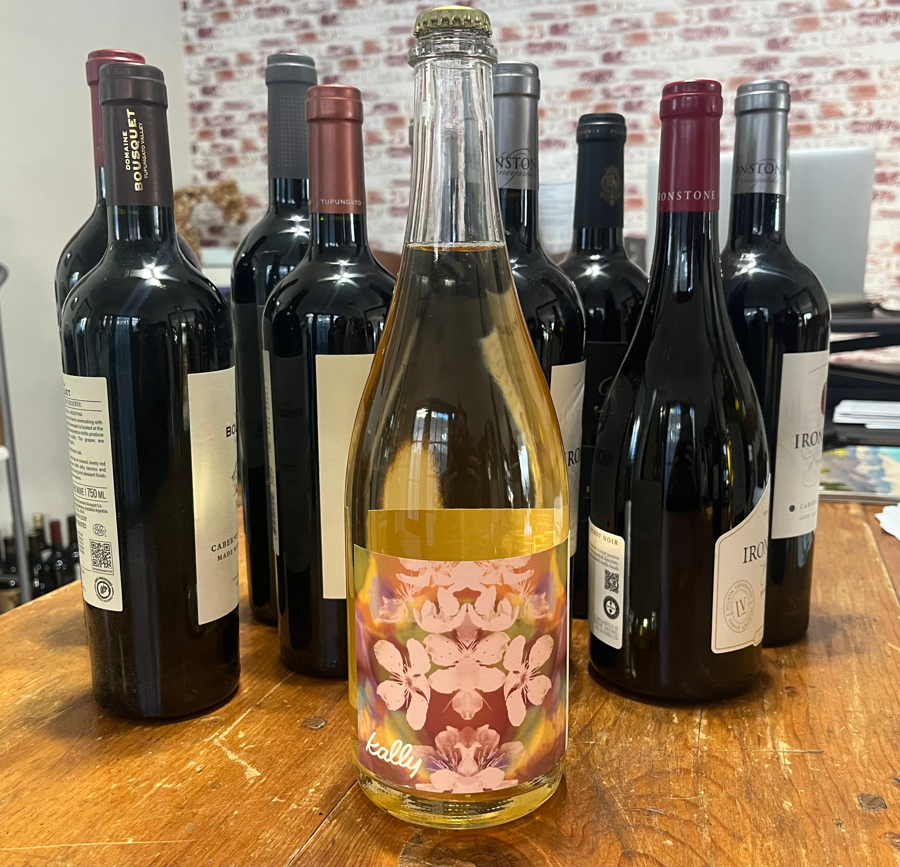 bottle of nonalcoholic wine in front of bottles of real wine