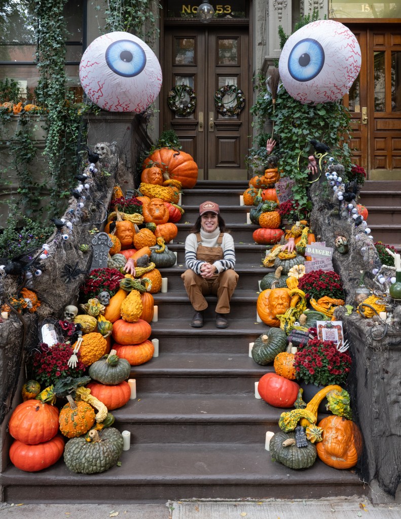Hillary Simon sitting on her Halloween-themed stoop at 153 West 82nd Street, NY, NY.