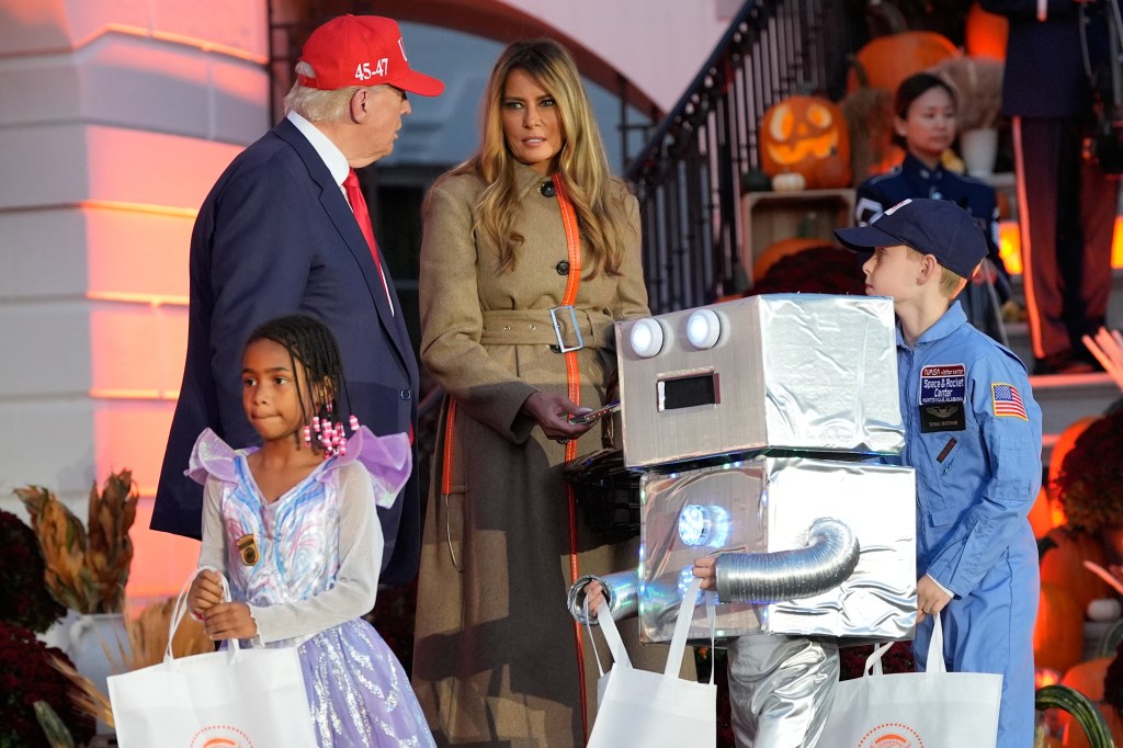 President Donald Trump and First Lady Melania Trump distribute Halloween treats to children.