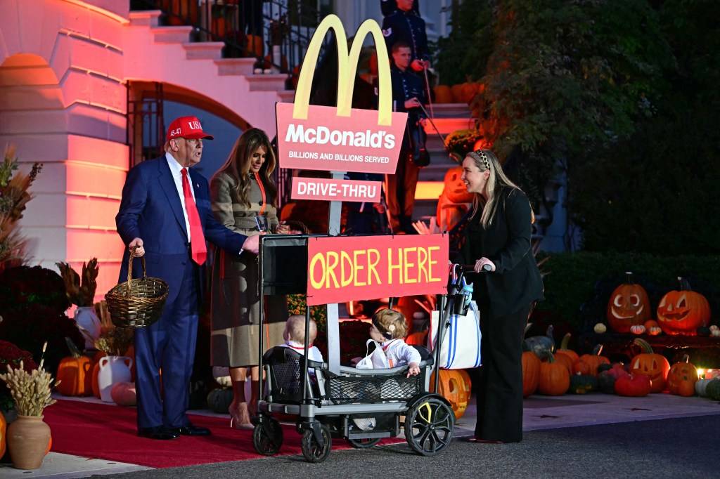 Donald and Melania Trump greet trick-or-treaters at a Halloween event outside the White House.