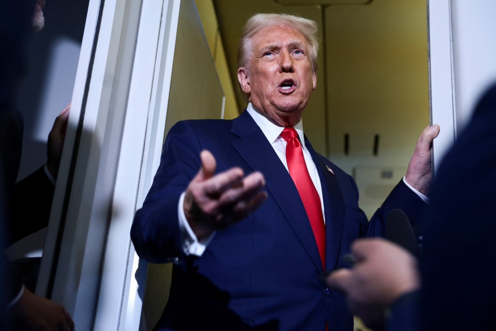 U.S. President Donald Trump speaks to members of the media on Air Force One.