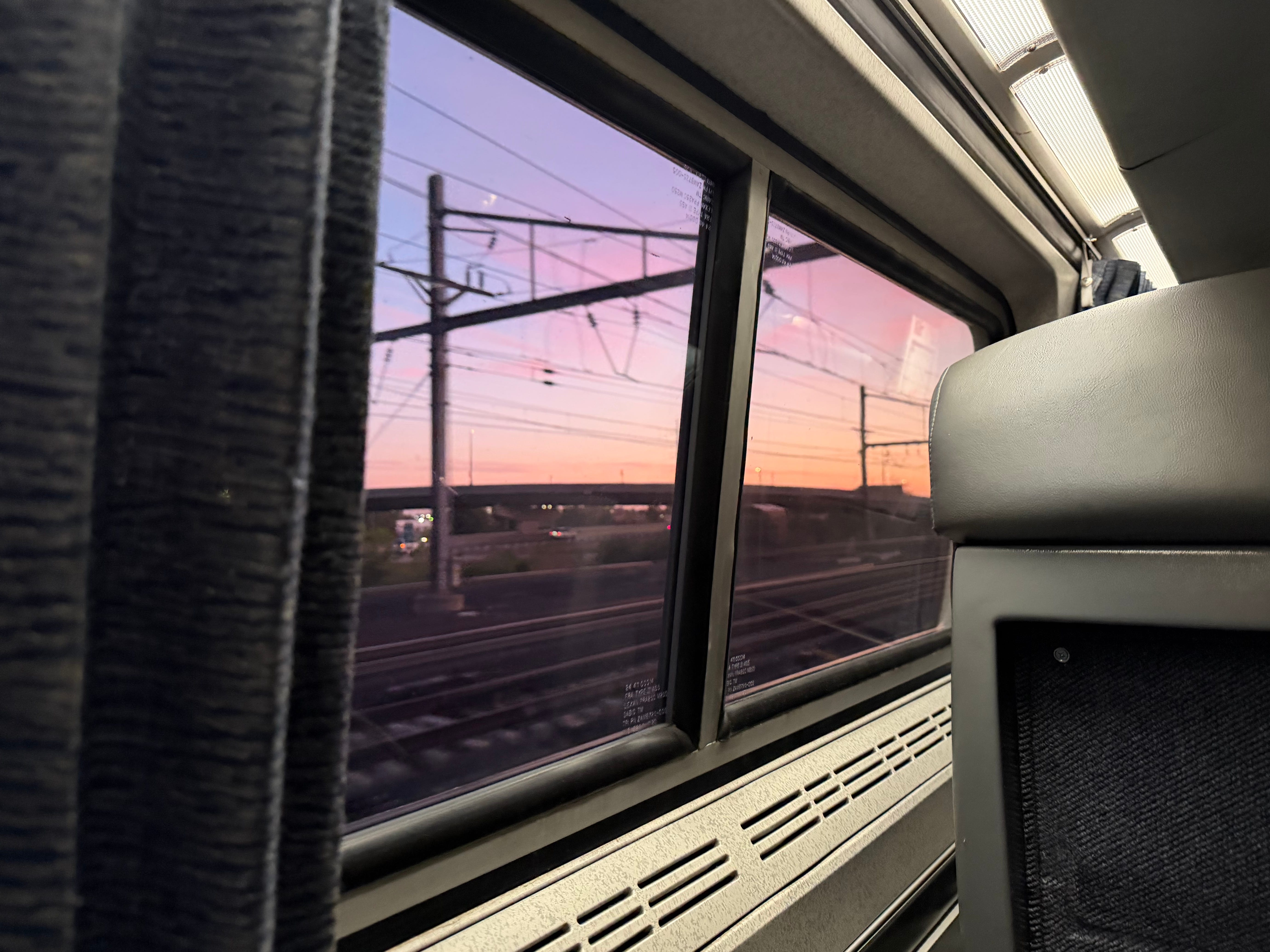 A colorful sunrise outside an Amtrak window.