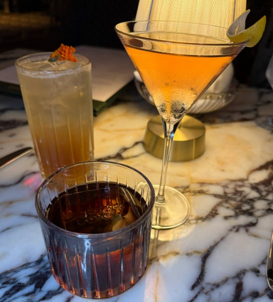 Three cocktails on marble table at 1587 Prime