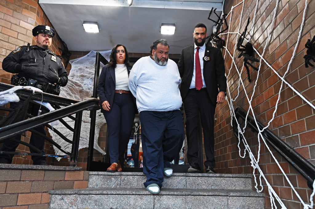 Domingo Vasquez Rodriguez being escorted by NYPD Detectives out of the 34th Precinct.