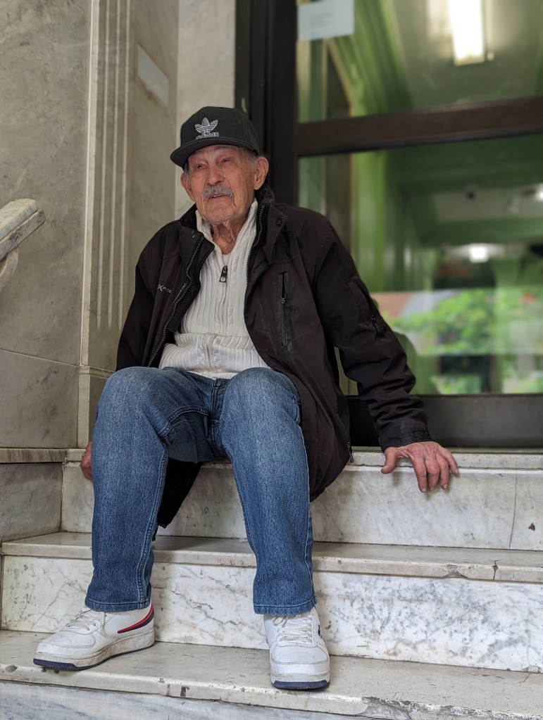 Jose Antonio Tur, a 99-year-old landlord, sitting on marble steps.