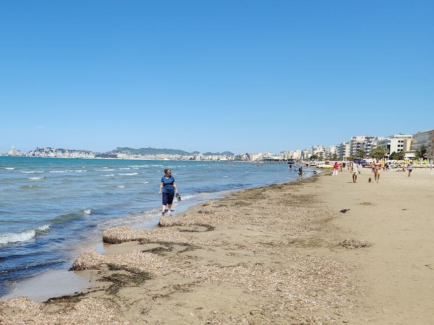 Sandra Mayernik walking along a beach in Durres, Albania.
