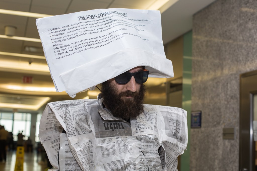 Aaron Akaberi in the hallway at the New York State Supreme Courthouse at 320 Jay Street in downtown, Brooklyn on Wednesday September 14, 2016 in New York City, USA. Akaberi is dressed in hebrew newsprint as part of a protest at being briefly remanded by a judge for reading the torah in a courtroom, while waiting for his case to be called. Akaberi is charged with a various crimes related to possession of controlled substances.