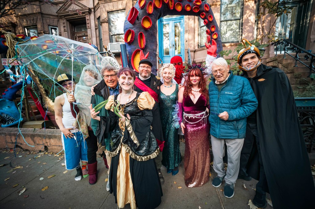 A group of people in Halloween costumes on 11th Street in Park Slope.