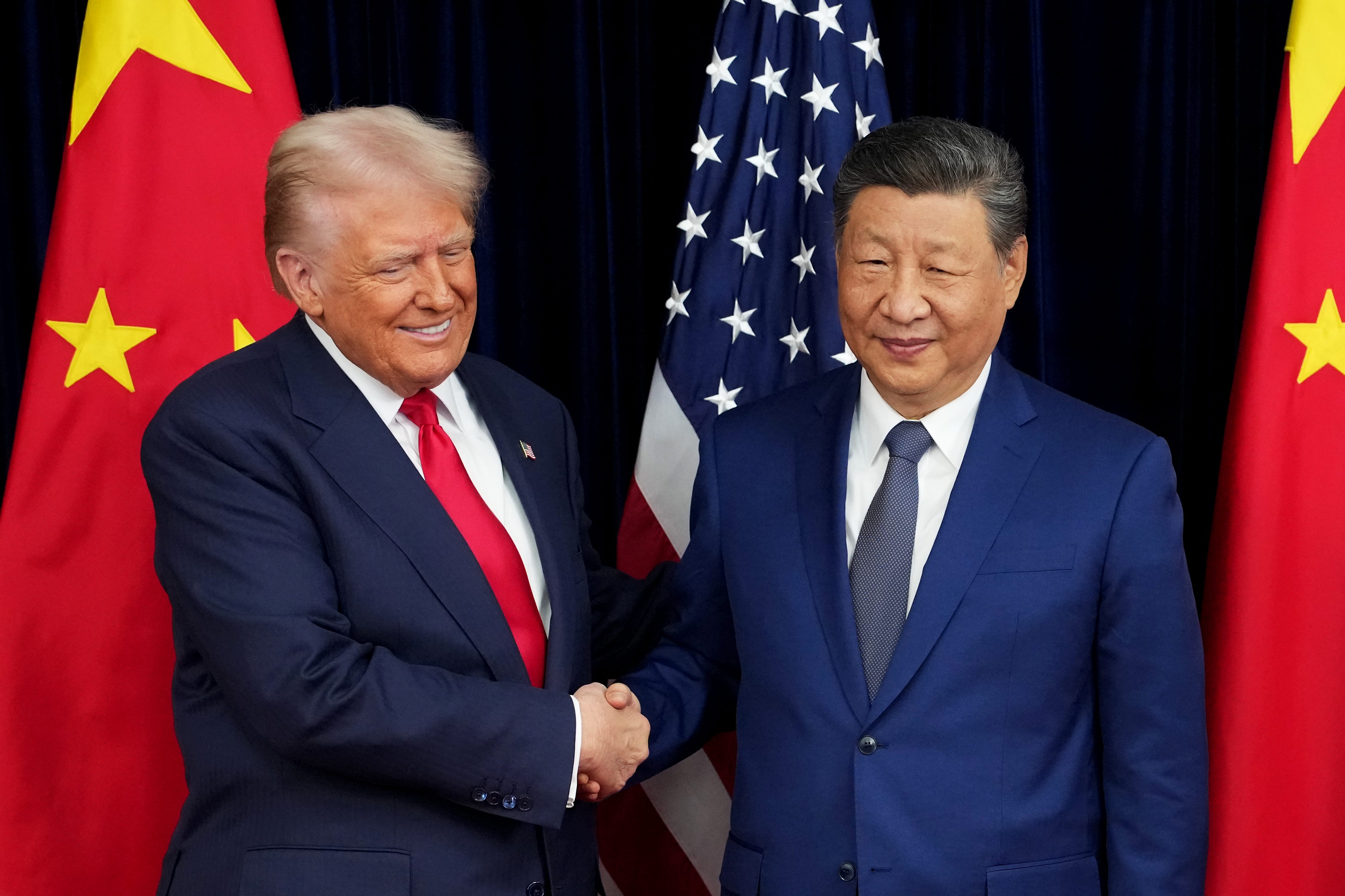 US President Donald Trump greets Chinese leader Xi Jinping ahead of a bilateral meeting at Gimhae Air Base in Busan, South Korea, on October 30, 2025.