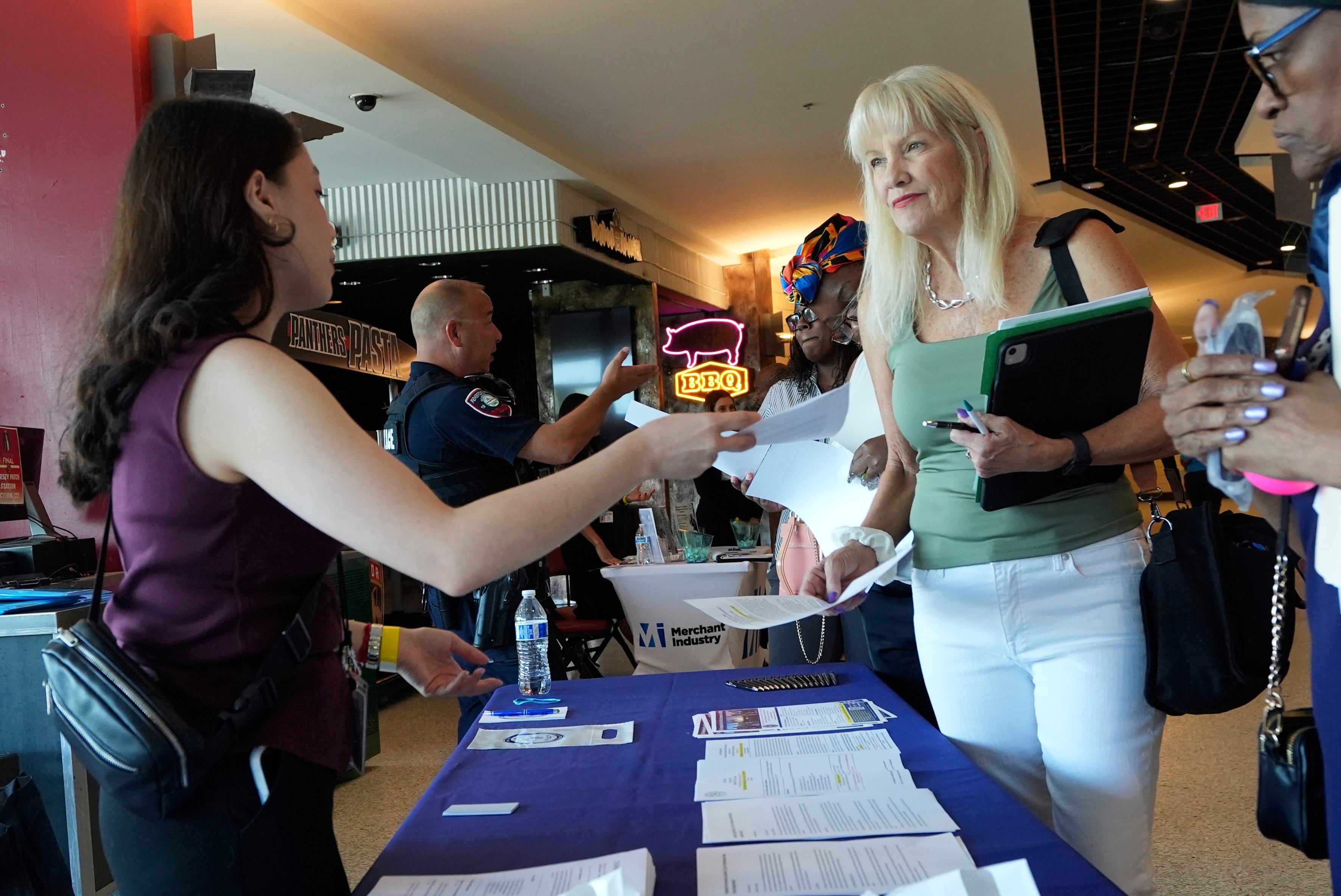 A job seeker talks to a recruiter at a Florida job fair